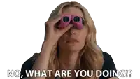 a woman looking through binoculars with the words " no what are you doing " written below her