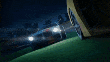a yellow car with red lights on the back is driving on a track