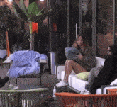 a woman is sitting on a couch holding a pillow .