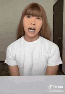 a woman in a white shirt has a tiktok watermark
