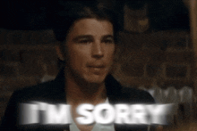 a man says " i 'm sorry " in a blurry image
