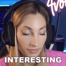 a woman wearing headphones with the word interesting on the bottom right