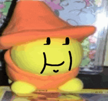 a cartoon character with a hat on has a smiley face drawn on its face