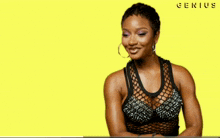 a woman is smiling in front of a yellow background with the word genius written on it
