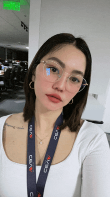 a woman wearing glasses and a lanyard that says cavs