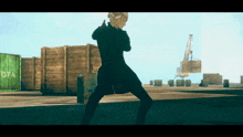 a man in a black coat is standing in front of a green container that says ota