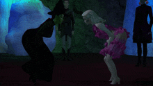 a woman in a witch hat is kneeling down next to a little girl in a pink dress
