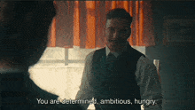 a man with a mustache is talking to another man who says you are determined ambitious hungry