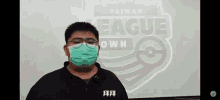 a man wearing a mask and glasses is standing in front of a screen that says taiwan league own .