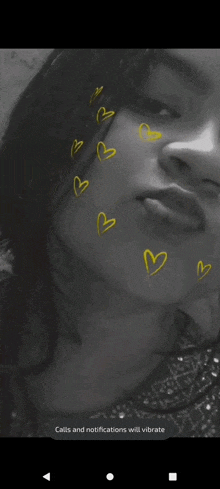 a close up of a woman 's face with yellow hearts on it .