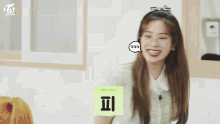 a group of girls are sitting in a classroom with a twice logo behind them