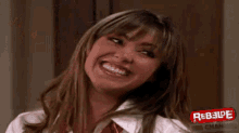 a close up of a woman 's face with a rebelde logo on it .