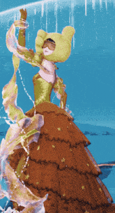 a woman in a green and brown dress is dancing