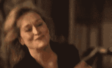 a close up of a woman making a funny face with her eyes closed .