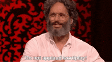 a man with glasses and a beard is saying do not applaud wordplay