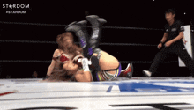two women wrestling in a ring with the word stardom on the bottom right