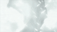 a silhouette of a person standing in the snow with white feathers flying around them .