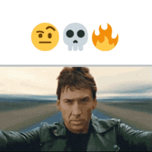 a man taking a selfie with a skull and fire emoji behind him