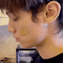 a close up of a man 's face with a bandage on his face