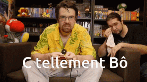 a man sitting on a couch playing a video game with the words c'tellement bo