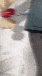 a blurry picture of a person standing in front of a white wall .