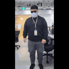a man wearing a mask and sunglasses is standing in front of an exit sign