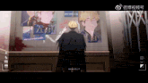 a video of a man standing in front of a wall with a picture of a man with the word xixi on it