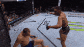two men in a boxing ring with ufc written on the ground