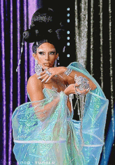 a picture of a drag queen with a purple curtain behind her and the word tumblr at the bottom