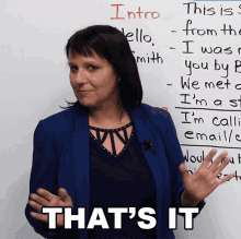 a woman stands in front of a whiteboard with the words that 's it on it