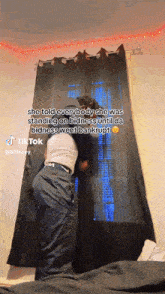 a man is standing in front of a window with a tiktok caption