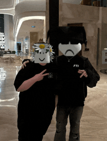 two people standing next to each other with one wearing a shirt that says fti on it