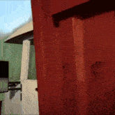 a red door is open to a white room