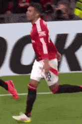 a soccer player wearing a red jersey with the number 18 on it
