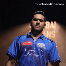 a man wearing a blue shirt that says indians on it