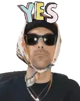a man wearing sunglasses and a scarf has the word yes above his head