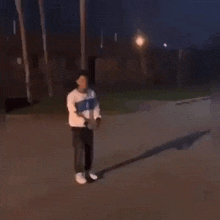 a man is flying through the air while another man is standing next to him .