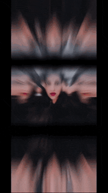 a blurry picture of a woman 's face with a black background