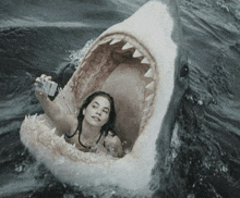 a woman is taking a selfie with a shark in the water