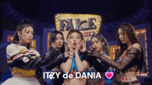 a group of young women are standing next to each other in front of a sign that says itzy de dania