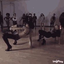 a group of women are dancing in a room with the words imgplay visible on the bottom