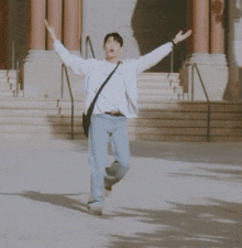 a man with his arms outstretched is wearing a white jacket with the letter j on it