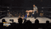 two wrestlers in a ring with a nwa logo on the bottom right