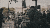 a man is playing drums on stage in front of a crowd .