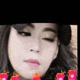 a close up of a woman 's face with flames around her