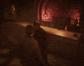 two men are standing in a dark room with barrels