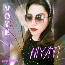a woman wearing sunglasses and a headband with the name niyati