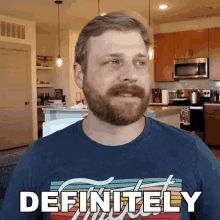 a man with a beard wearing a blue shirt that says definitely