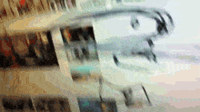 a blurred image of people walking in a building with the word ' a ' on it