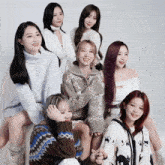 a group of girls are posing for a picture and one girl has purple hair